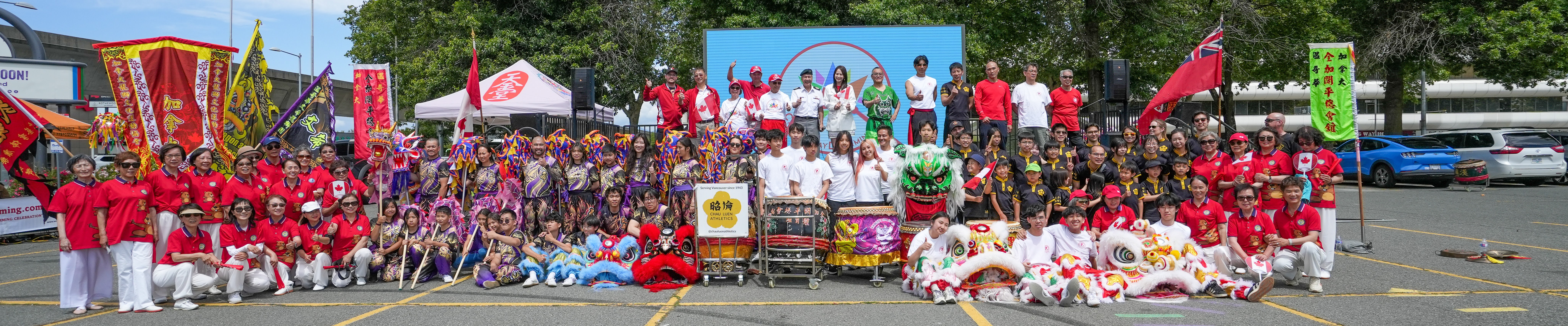 Lion dance performers on an outdoor festival stage with a crowd watching